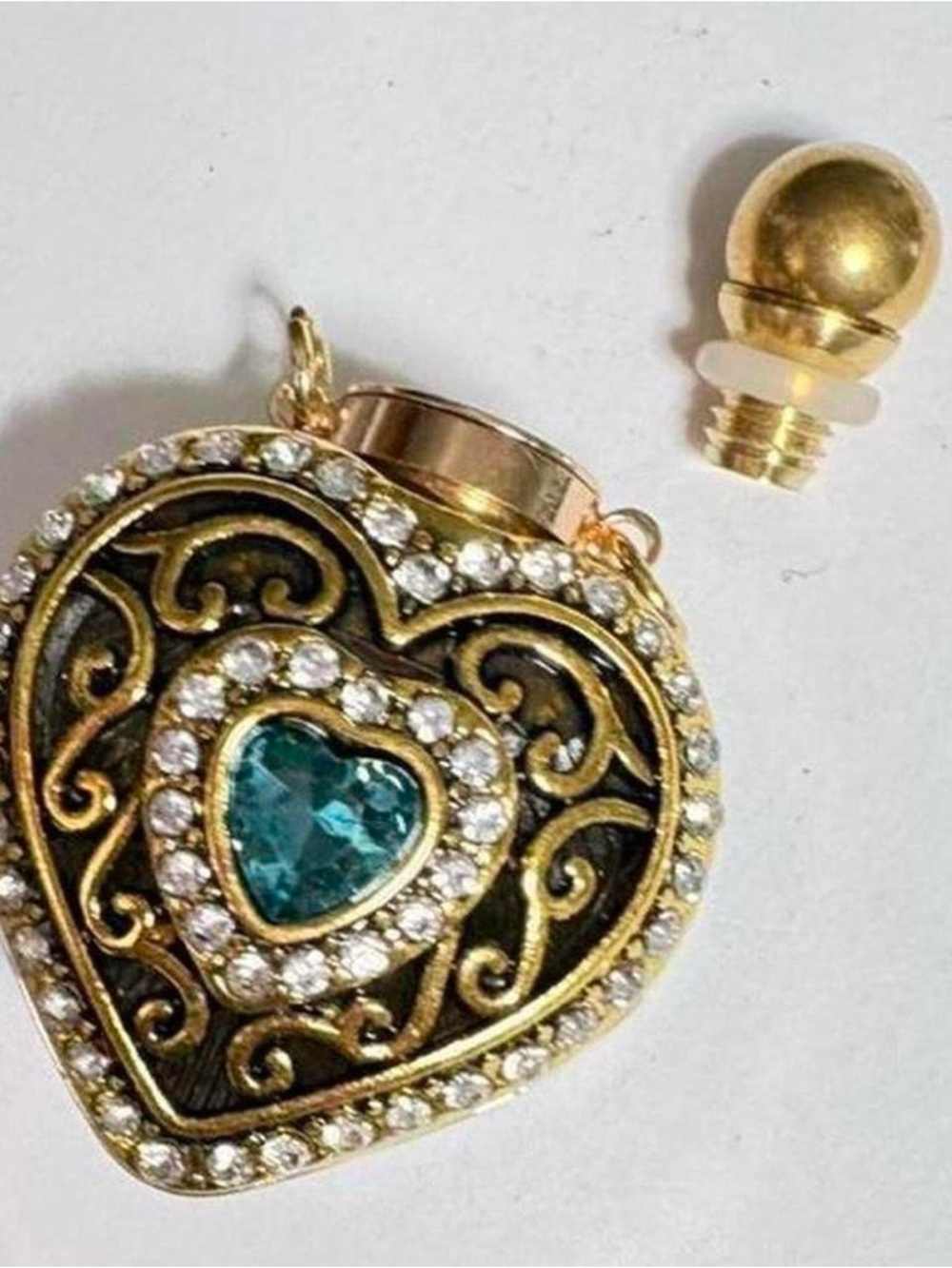 Vintage inspired intricate Gold
tone heart potion bottle